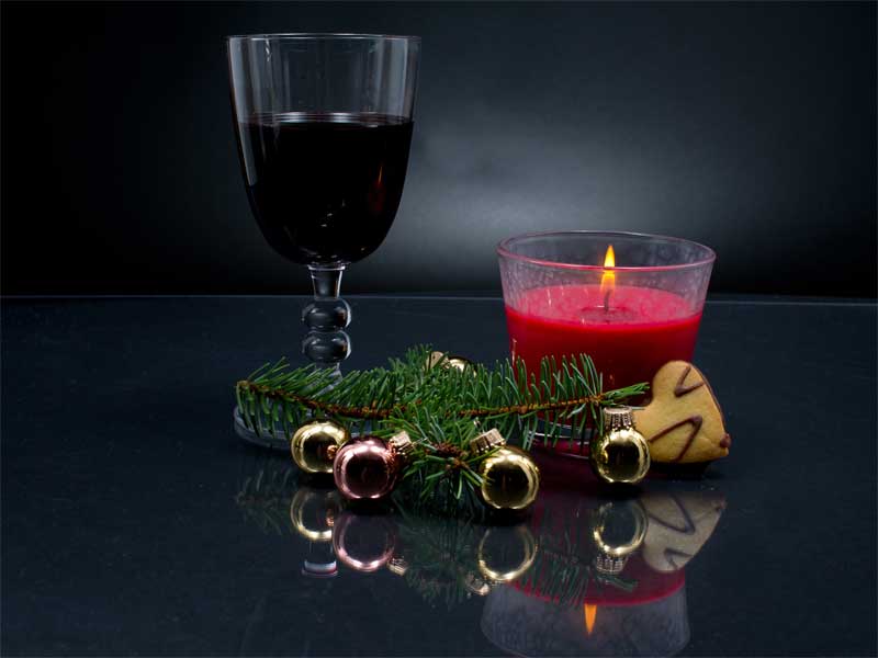 Glass of red wine with a Christmas decoration
